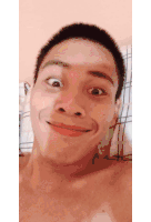 a shirtless man making a funny face with his eyes closed