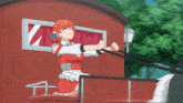 a girl in a red dress is pulling a wagon through a flooded area
