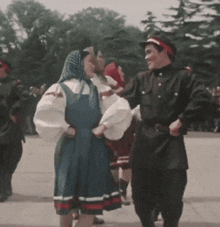 a man and a woman are dancing together in front of a crowd .