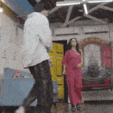 a man and a woman are standing in a room