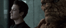 a man in a black shirt looks at the thing