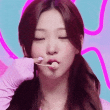 a woman with red hair is eating a lollipop with a toothpick .
