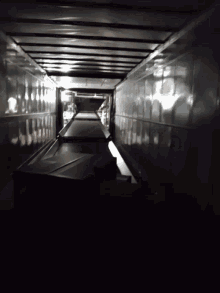 a dark hallway with a few lights on the walls