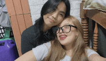 two girls are posing for a picture and one has her tongue out