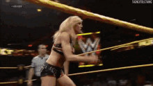 a woman in a wrestling ring with the words thenextblcthing written on the bottom