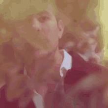 a close up of a man 's face behind a blurred background