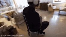 a person wearing a virtual reality headset is sitting in a chair
