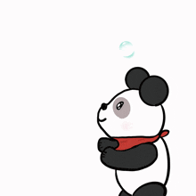 a panda bear blowing soap bubbles with a red scarf around his neck