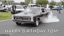 a car is driving down a road with smoke coming out of its tires .