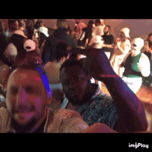 a group of people are dancing in a dark room with the words imgplay in the lower right corner