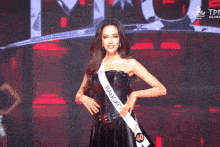a woman wearing a sash that says bangi