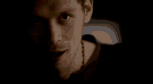 a woman 's face is shown in a dark room