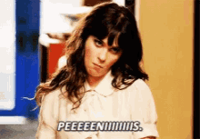 a woman in a white shirt is saying peeeeeen