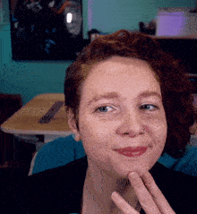 a woman with red hair has a nose ring on her left ear