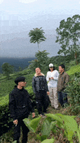 a group of people standing in a field with one man wearing a jacket that says ' i 'm a '