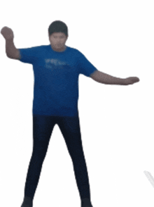 a man in a blue shirt and black pants is dancing with his arms outstretched