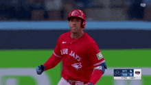 a baseball player for the blue jays is running on a field