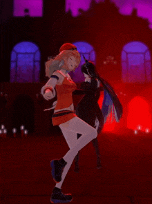 a girl in a red dress is dancing with another girl in a black dress