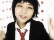 a woman wearing a suit and tie is making a funny face