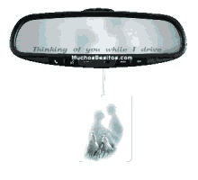 a rear view mirror with a picture of a couple and the words thinking of you while i drive