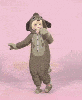 a girl in a dog costume stands on one leg
