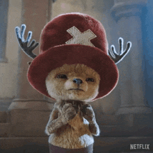 a stuffed animal with antlers and a hat that says shut up on it