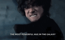 a man is making a face with the words `` the most powerful hug in the galaxy '' .