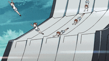 a group of people are sliding down a ramp with a blue sky in the background