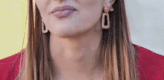 a close up of a woman 's neck and earrings .
