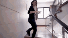 a woman walking down a set of stairs with the words made in animatica on the bottom