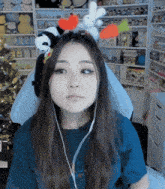 a woman wearing a headband with stuffed animals on it looks at the camera