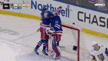 a hockey game is being played in front of an ad for northwell
