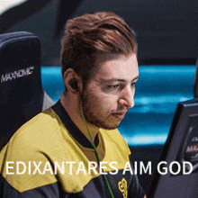 a man sitting in front of a computer with the words edixantares aim god written on the bottom