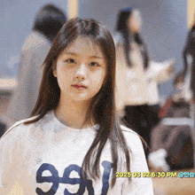 a girl wearing a white shirt that says 99 on it