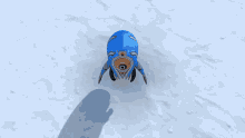 a person wearing gloves is holding a blue object