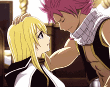 a man with pink hair is touching the head of a woman