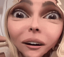 a close up of a woman 's face with a surprised expression on her face