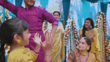 a group of people are dancing together in a room .