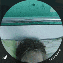 a person laying on a bed with a telegram icon on the bottom