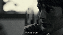 a man in a suit says that is true in a black and white photo