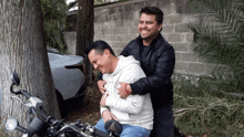 a man on a motorcycle with a hoodie that says ' abercrombie & fitch ' on the front