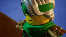 a close up of a lego figure with a green scarf around his head