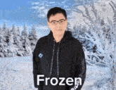 a man wearing a black hoodie with the word frozen on the front
