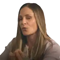 a woman with long blonde hair is making a face