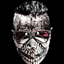 a man wearing sunglasses and a mask with skulls on it