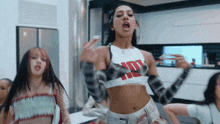 a woman wearing a crop top that says ' hot ' on it