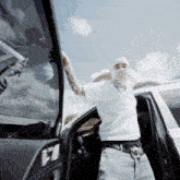 a man wearing a mask is getting out of a vehicle