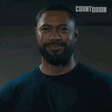 a man with a beard is smiling in front of a countdown logo