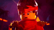 a close up of a lego figure with a red scarf around his neck