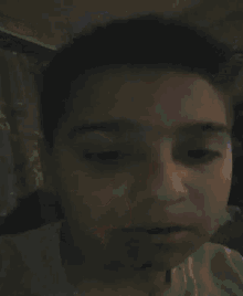 a blurred image of a person sitting in front of a tv